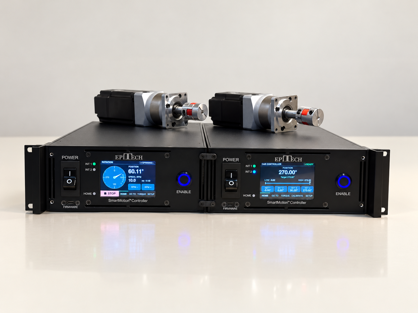 Two SmartMotion controllers and motors on a cream surface
