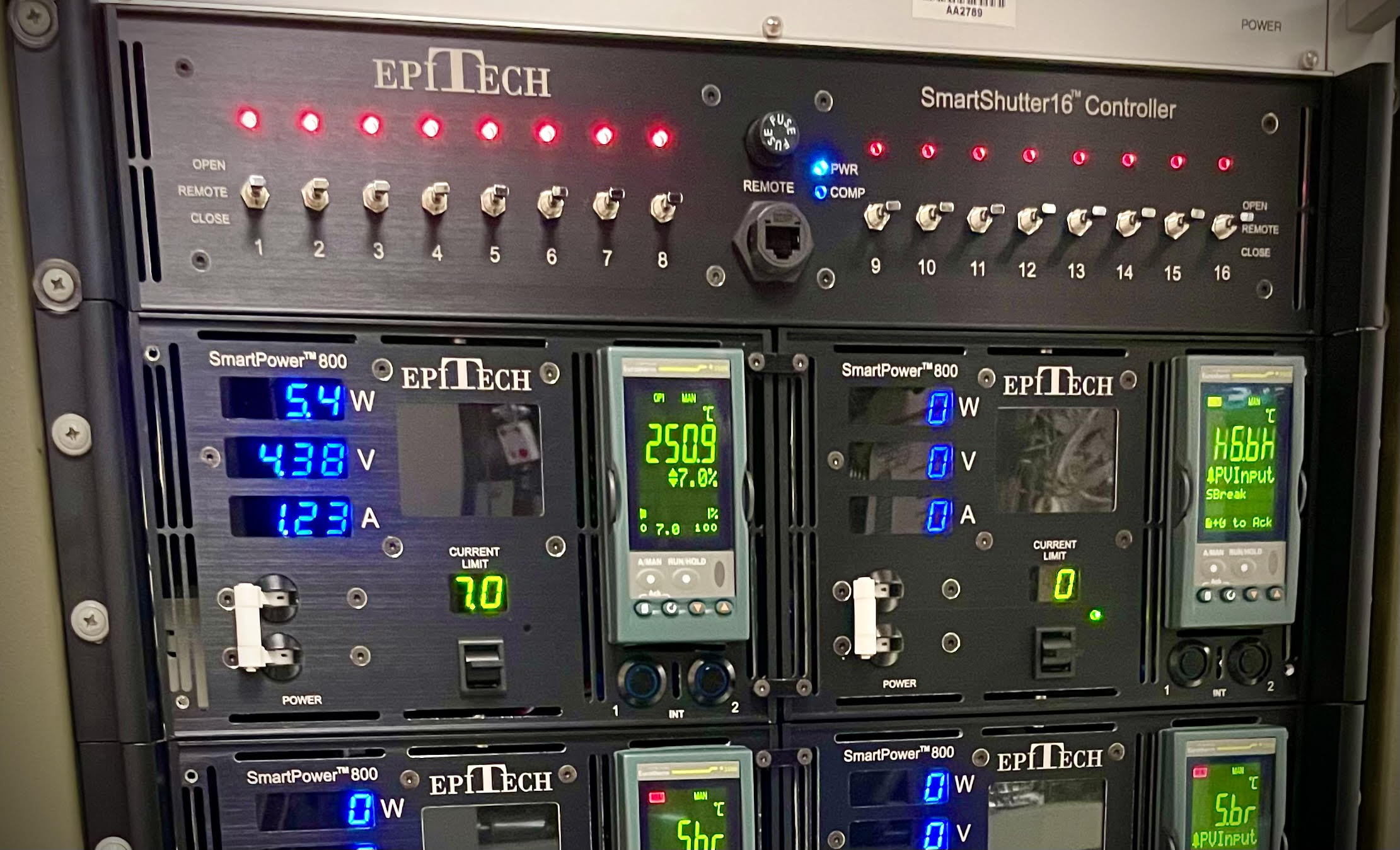 Installed EpiTech SmartShutter16 controller with sixteen front-panel switches and indicators, above two SmartPower supplies